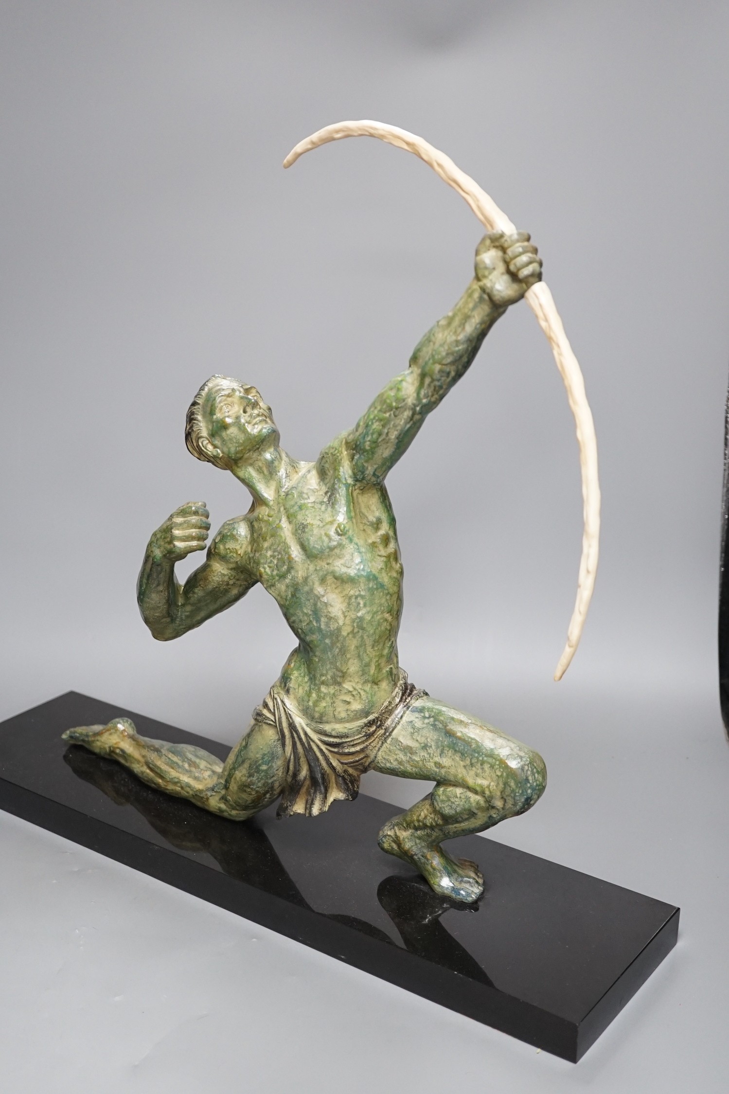 A large Art Deco bronzed figure of an archer, on black marble stand, 55 cms wide